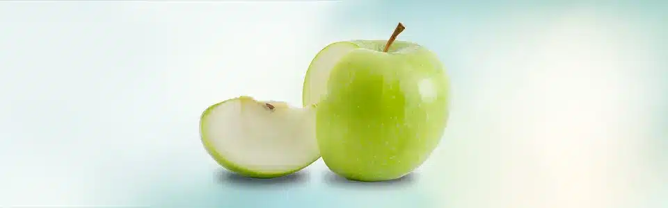 A green apple with a slice taken out of it