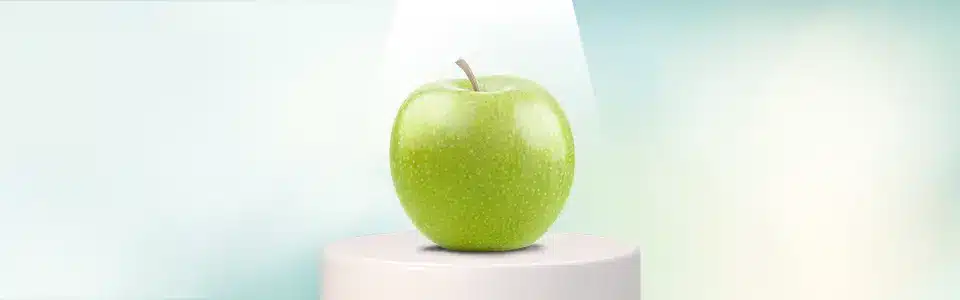 A green apple in the spotlight on a stage